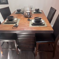 Wood counter Height Table And Four Leather Chairs. 