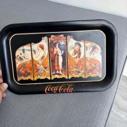 The item is a vintage Coca-Cola serving tray, a reproduction of a 1923 design …copyrighted  in 1990… 14 “ x 9”. $20