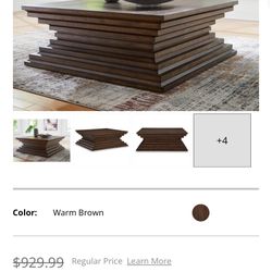 Upgrade your living room instantly. Brand new designer-style coffee table set from Ashley Furniture