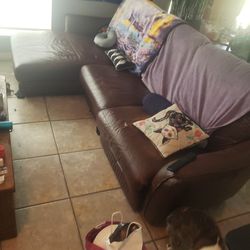 brown leather power recline couch with cat damage