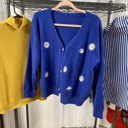 Gold Knit Vest, Royal Blue Cardigan With Daisys, And Royal Blue And White Striped Shirt With Buttons Down The Arm