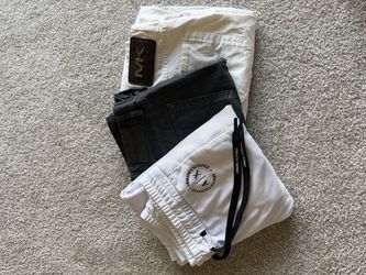 Two pairs of Michael Kors pants and one pair of Armani sweatpants.