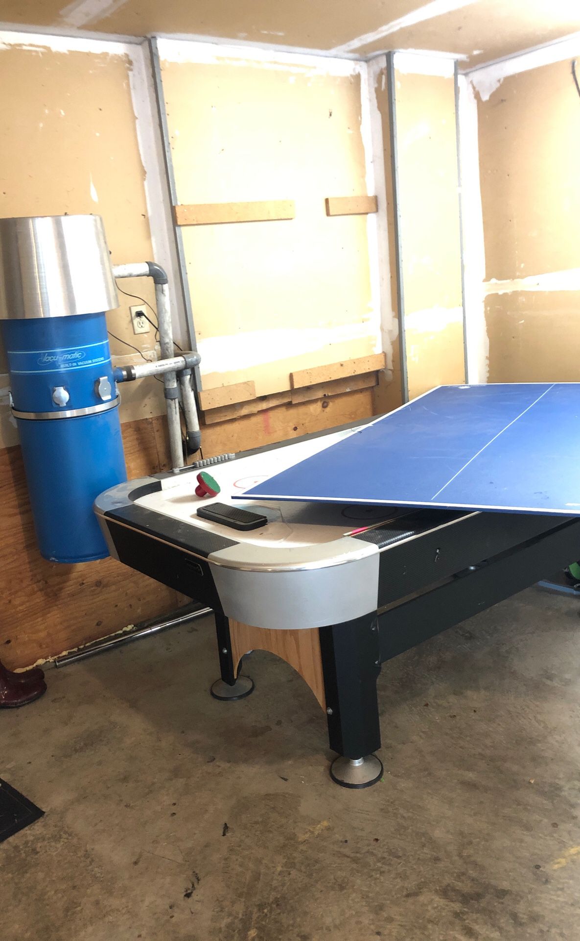 Air hockey table with ping pong table cover.