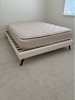 Modern platform bed frame wooden slat base and sleek black angled legs . Faux leather cream -colored bed frame 60”x80” for Queen mattress . ( mattress