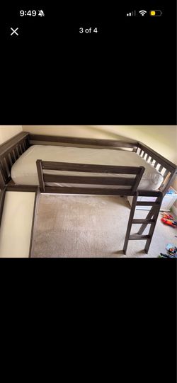 Low loft bed with slide and dinosour curtains