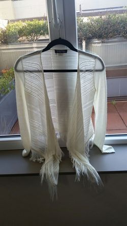 Long sleeved fringed cardigan.