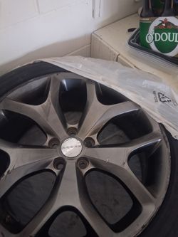 Four Dodge alloy wheels with tires. Wheels are wrapped in plastic bags. Has some scuffs on rims nothing too serious Tires manufacturers year 2023