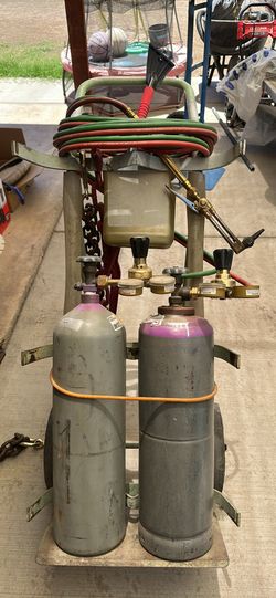 Cutting torch with two tanks and car