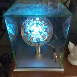 Replica Of The Arc Reactor From Iron Man. Lights Up When Taft, Blinks When Tapped Twice, And Has The Saying 'Proof That Tony Stark Has A Heart'