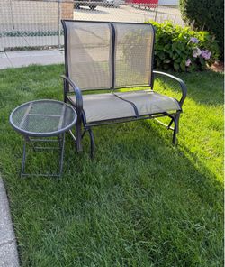 TWO SEATER GLIDER IN GOOD CONDITION  WITH ROUND SIDE TABLE. BLACK METAL FRAME. LIGHT WEIGHT . $100.00 OR BEST OFFER.