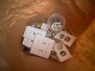 Mix of ex of white outlet covers and toggle light switch plates