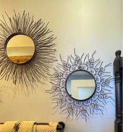 Three French vintage sunburst wall mirror features a unique rusted wrought iron frame with intricate scrollwork