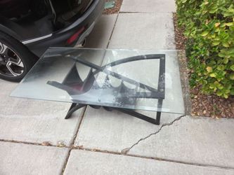Glass table with pouches underneath