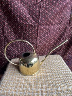 Gold colored watering can