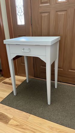 Sewing machine cabinet with extension