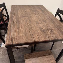 A dining table with 4 chairs