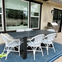 Dark concrete Onyx 84” Restoration Hardware table with 6 Serena and Lily Outdoor Riviera Chair