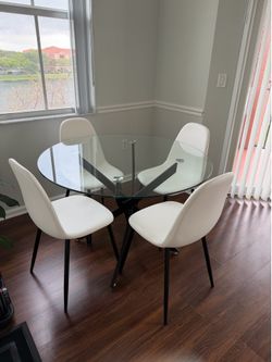 Havana glass 43” Round table with blac k legs and 4 Alba Ivory upholstered chairs