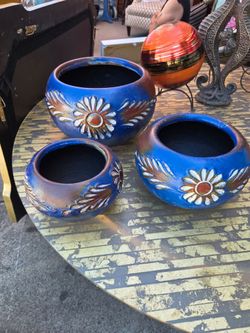 Set of handcrafted blue clay flowerpots with hand-painted decoration