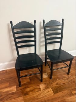 Two black wooden chairs