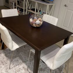 Brown bombay table for sale only . the white chairs are sold.
