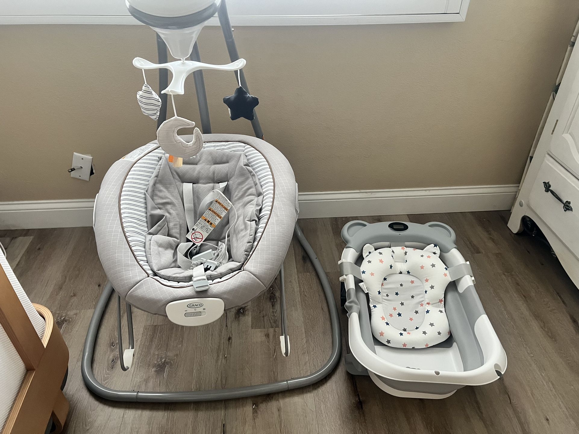 Brand new, Unused baby bath and motorized Graco swing with music and mobile And portable booster OBO