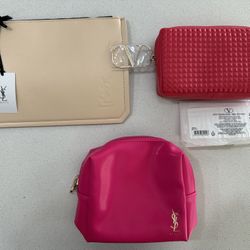 Set of 3 Yves Saint Laurent and Valentino beauty cosmetics bags for girls.
