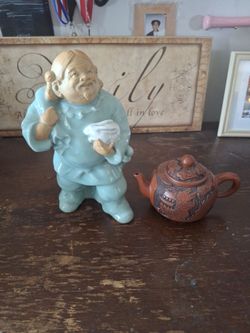 A god collectable statue of luck and a dragon teapot