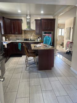 Bordeaux color kitchen cabinets , with island ,