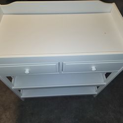 Changing table. It’s brown but it’s suppose to look like white one in picture. Open box but everything there
