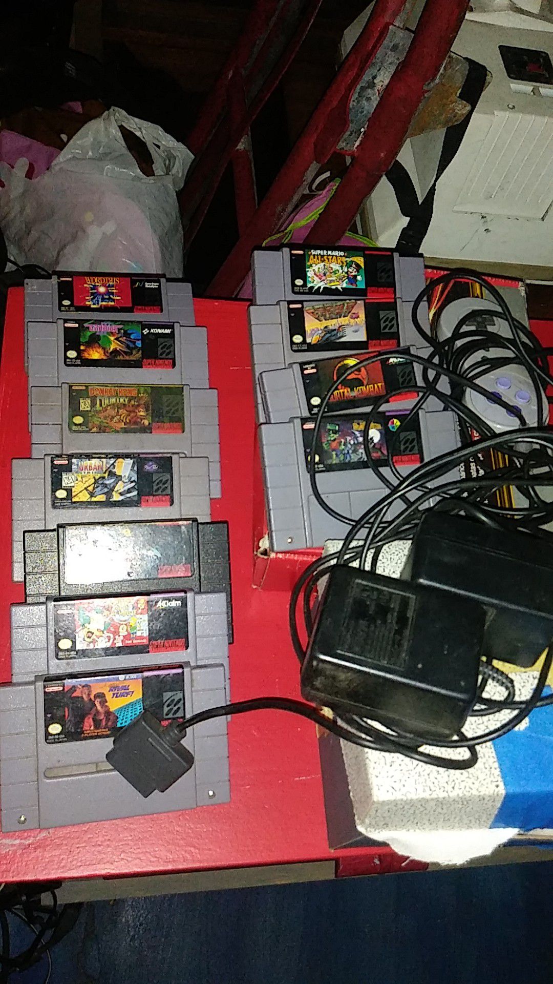 Lots of Super Nintendo games and cords adapter controller