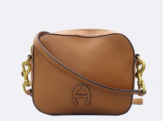 tan leather Etienne Aigner crossbody bag features a signature horseshoe logo detail
