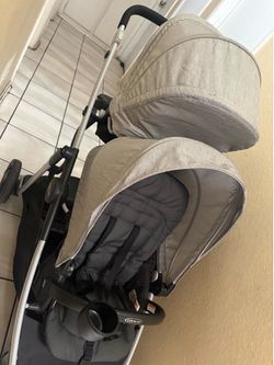 Double stroller baby and toddler and button seat