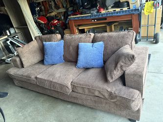 Brown Couch with brown & blue throw pillows