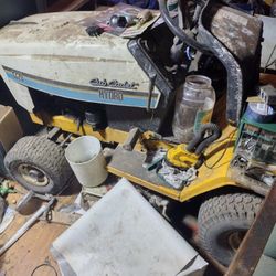 2 cub cadet riding mower and 1 craftsman lawn mower and a quad