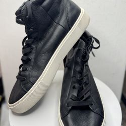 These are black leather high-top UGG sneakers.
