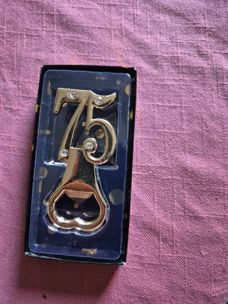 BOTTLE OPENER WITH A NEMBER 75 ORIGINAL PRICE $75.