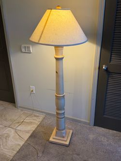 Classic Floor Lamp with Light Wood Finish and Cream Color Shade.