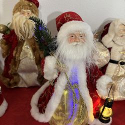 Eight Santa Figurines including a Lighted Santa Claus Fiber Optic Christmas Tree topper