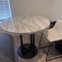 Table and 4 white chairs 