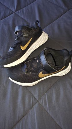 Nike black n gold shoes