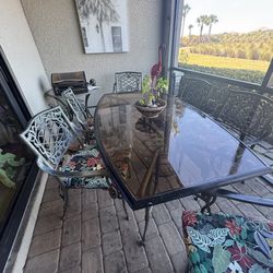 Cast iron table & 6 chairs / 2 swivel & Band new cushions