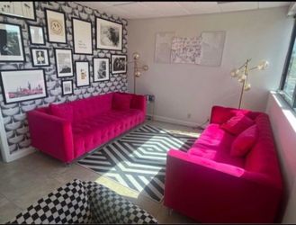 Two large hot pink couches