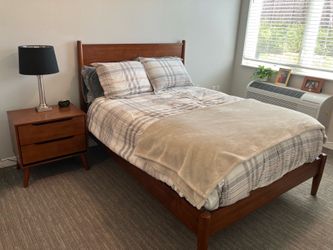 Full-size bed with dresser and nightstand, leather recliner, couch, and small kitchen table with two chair chairs