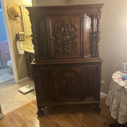 This is an antique Jacobean or Jacobean Revival style oak china cabinet.