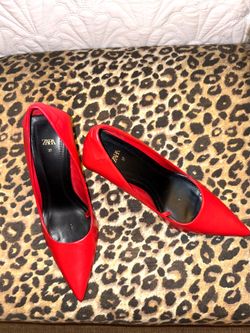 Red high-heeled shoes from Zara, designed with a pointed toe.