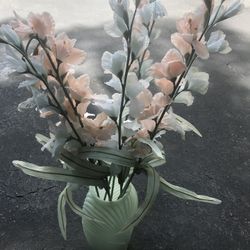 Artificial flowers in glass vase 