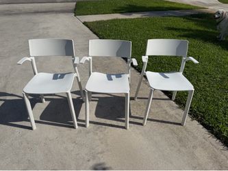 This IKEA JANINGE chair in white features a stackable design with armrests. All 3 for $50