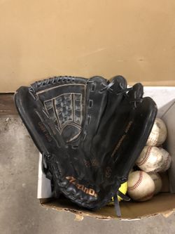 2 baseball mitts and a box of assorted balls