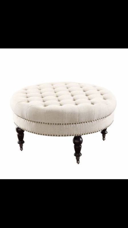 White round tufted ottoman.